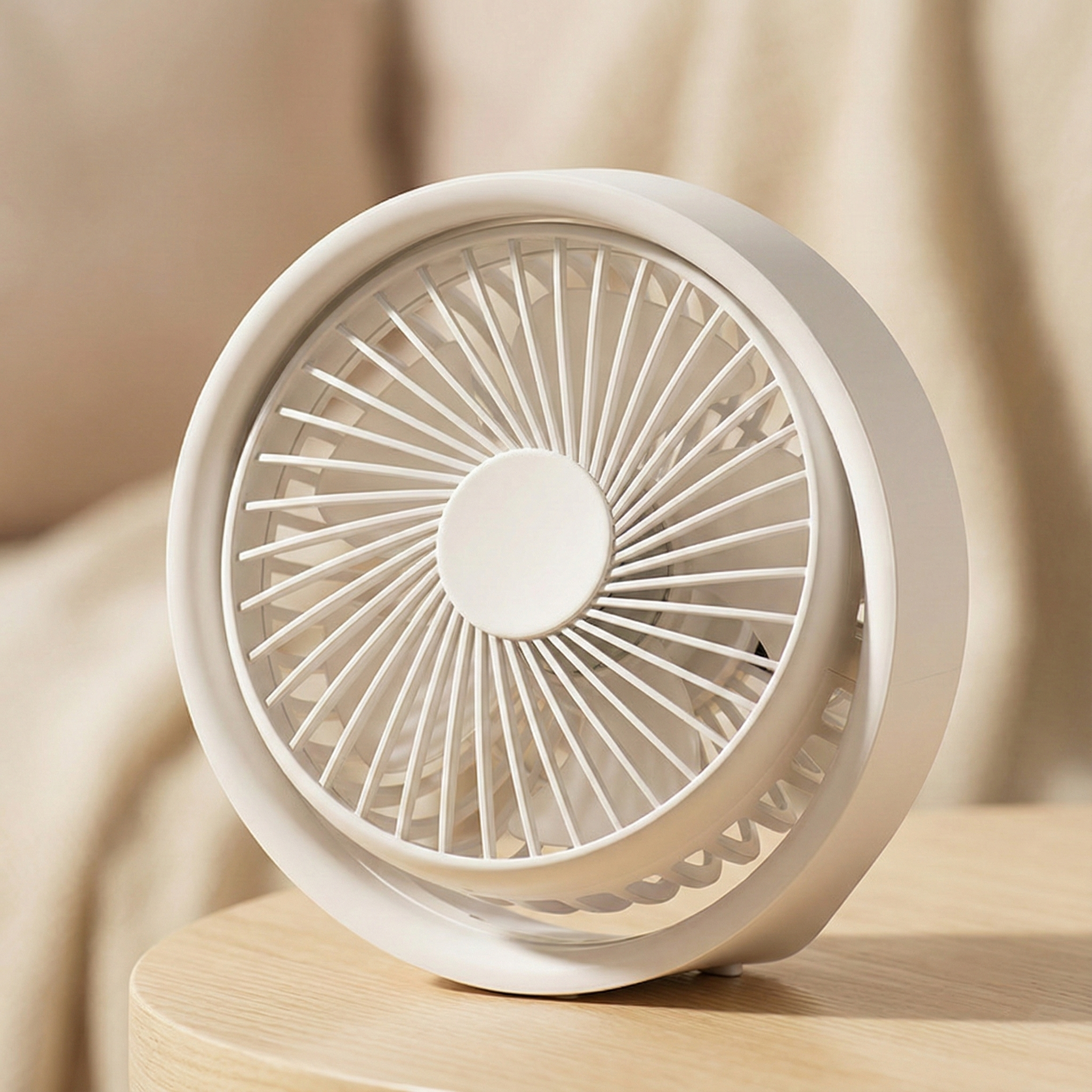 White portable fan on a beige fabric background